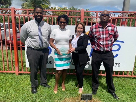 Gilbert Augustin (Executive Director), Cassandre Joseph (Direct Support Professional), Yusdary Rodriguez (Residential Program Director), and Patrick Brown (Director of Operations) posing with Cassandre's 2021 Florida Direct Support Professional of the Year award.